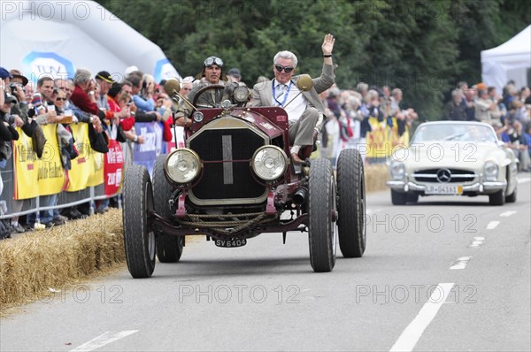 Passenger of a red classic car waves to the crowd at a car race, SOLITUDE REVIVAL 2011, Stuttgart, Baden-Wuerttemberg, Germany, Europe