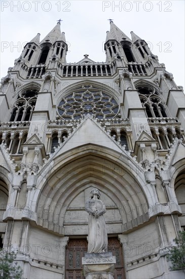 Church of Saint-Vincent-de-Paul, The facade of a Gothic church with detailed sculptures against a grey sky, Marseille, Departement Bouches-du-Rhone, Provence-Alpes-Cote d'Azur region, France, Europe