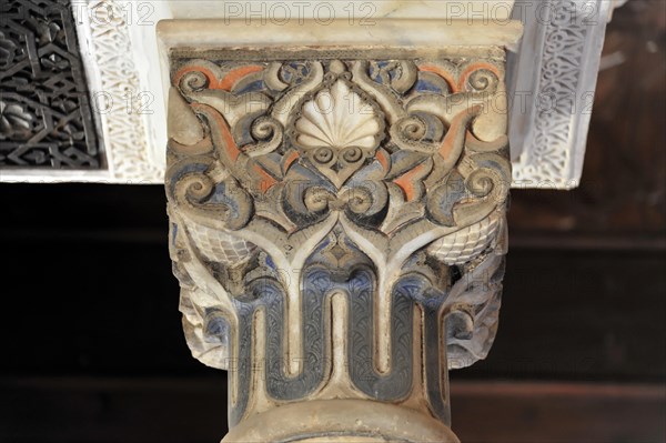 Artistic stone carvings, Alhambra, Granada, detail of a decorated antique column with blue and orange ornaments, Granada, Andalusia, Spain, Europe