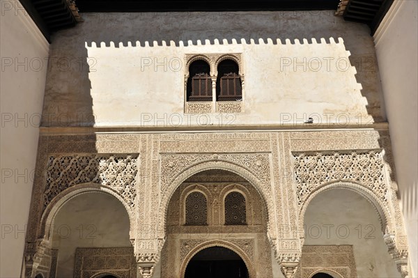 Artistic stone carvings, Alhambra, Granada, View of a Moorish courtyard with ornate arches and column constructions, Granada, Andalusia, Spain, Europe