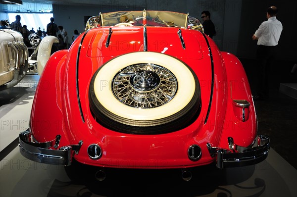 Rear view of a red vintage convertible with eye-catching chrome details, Mercedes-Benz Museum, Stuttgart, Baden-Wuerttemberg, Germany, Europe
