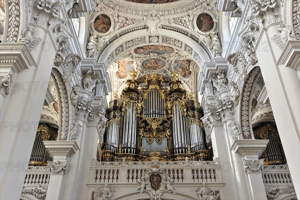 St Stephen's Cathedral, Passau, magnificent baroque-style organ with detailed carvings in front of decorative ceiling frescoes, Passau, Bavaria, Germany, Europe