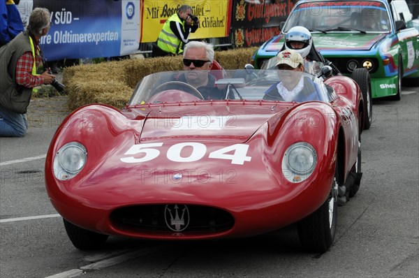 A red vintage sports car with a driver in a helmet at a race, SOLITUDE REVIVAL 2011, Stuttgart, Baden-Wuerttemberg, Germany, Europe