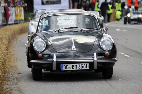 A black Porsche classic car takes part in a street race with spectators, SOLITUDE REVIVAL 2011, Stuttgart, Baden-Wuerttemberg, Germany, Europe