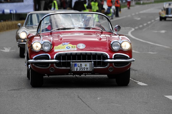 A red Corvette Cabriolet at a street race, surrounded by spectators, SOLITUDE REVIVAL 2011, Stuttgart, Baden-Wuerttemberg, Germany, Europe