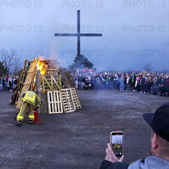 The fire brigade lights the Easter bonfire on the Haniel spoil tip in front of the summit cross, Bottrop, Ruhr area, North Rhine-Westphalia, Germany, Europe