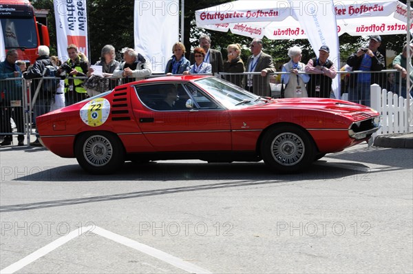 Red classic sports car drives past a crowd at a classic car race, SOLITUDE REVIVAL 2011, Stuttgart, Baden-Wuerttemberg, Germany, Europe
