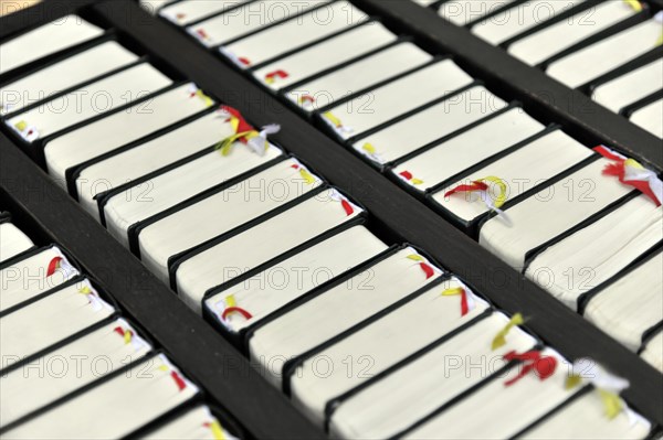 The Neumuenster Collegiate Abbey, Diocese of Wuerzburg, Kardinal-Doepfner-Platz, close-up of hymnals, Wuerzburg, Lower Franconia, Bavaria, Germany, Europe