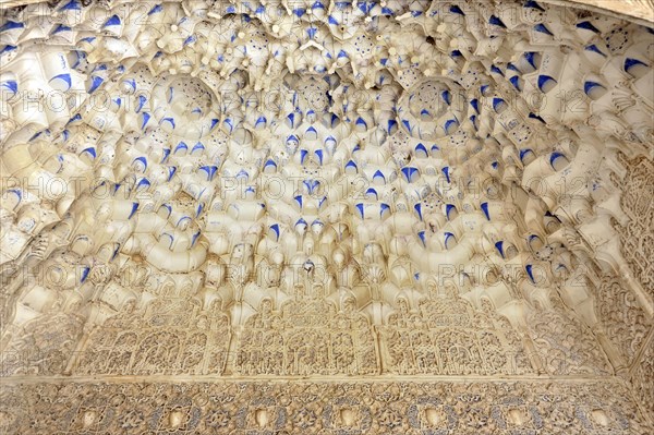 Artistic stone carvings, Alhambra, Granada, The stucco ceiling of a historic building with arabesques and blue accents, Granada, Andalusia, Spain, Europe