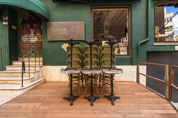 Palma de Mallorca, Spain, October 30 2023: stacked chairs in front of closed spanish cafe, Europe