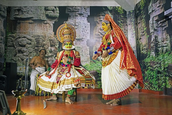 Kathakali performer or mime, 38 and 60 years old, and drummer on stage at the Kochi Kathakali Centre, Kochi, Kerala, India, Asia