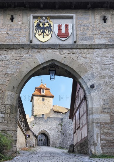 View through the Kobolzell Gate with front gate, Kobolzell Tower and town coat of arms, Rothenburg ob der Tauber, Middle Franconia, Bavaria, Germany, Europe