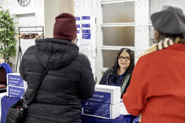 Detroit, Michigan, A representative for DTE Energy hands out energy-saving LED light bulbs at a community health fair