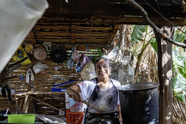 San Pablo Huitzo, Oaxaca, Mexico, Farmers are part of a cooperative that uses agroecological principles. They avoid pesticides and other chemicals, and recycle nutrients through the use of organic fertilizers. Magdalena Balbina Avendano Ruiz cooks lunch for visitors, using ingredients grown on the farm, Central America