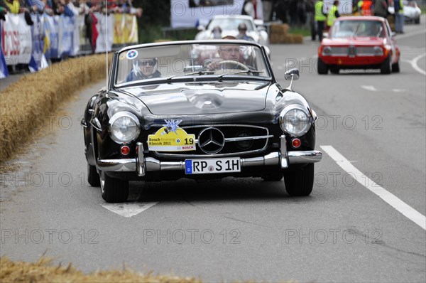 A black Mercedes-Benz classic car during a race with spectators in the background, SOLITUDE REVIVAL 2011, Stuttgart, Baden-Wuerttemberg, Germany, Europe