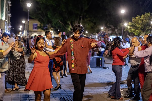 Oaxaca, Mexico, The weekly Wednesday dance in the zocalo, or central square. This night the dance was on Valentine's Day, with many dancers wearing red, Central America