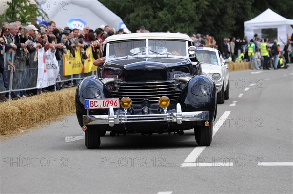 A black vintage car on a race track accompanied by a dense crowd, SOLITUDE REVIVAL 2011, Stuttgart, Baden-Wuerttemberg, Germany, Europe