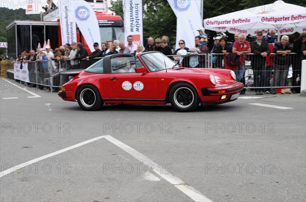 Red Porsche 911 driving on a road at a car event, SOLITUDE REVIVAL 2011, Stuttgart, Baden-Wuerttemberg, Germany, Europe