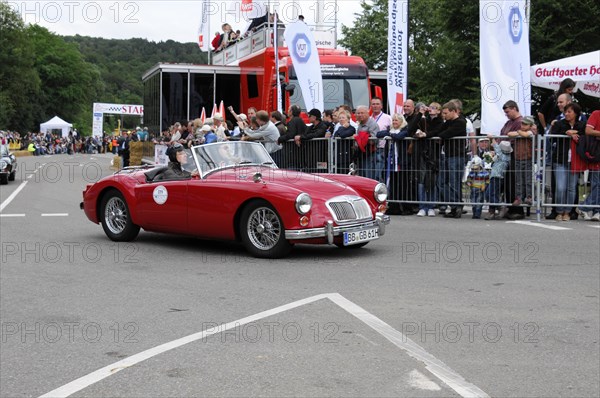 A red convertible vintage car drives on a road at an event, SOLITUDE REVIVAL 2011, Stuttgart, Baden-Wuerttemberg, Germany, Europe