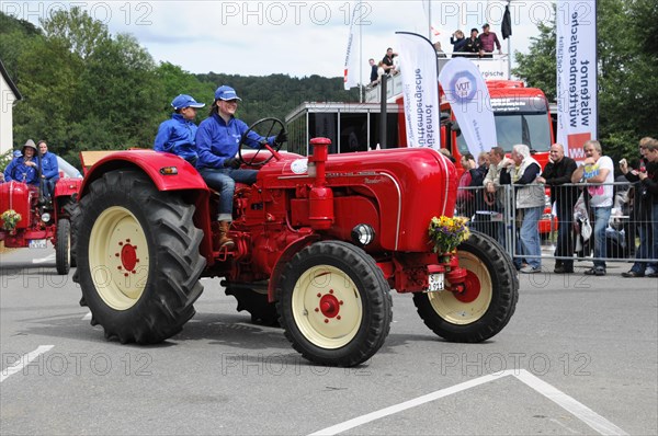 Porsche Diesel Tractors, A red vintage tractor is presented at an event, driver in blue overall, SOLITUDE REVIVAL 2011, Stuttgart, Baden-Wuerttemberg, Germany, Europe