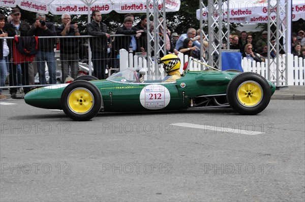 A green and yellow historic racing car with number 212 surrounded by spectators, SOLITUDE REVIVAL 2011, Stuttgart, Baden-Wuerttemberg, Germany, Europe
