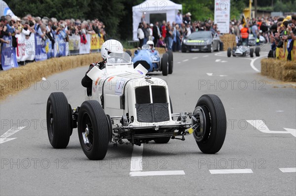 A white vintage racing car at a racing event, surrounded by spectators, SOLITUDE REVIVAL 2011, Stuttgart, Baden-Wuerttemberg, Germany, Europe