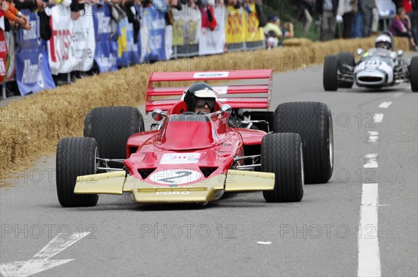Red formula car in racing action, surrounded by bales of straw and spectators, SOLITUDE REVIVAL 2011, Stuttgart, Baden-Wuerttemberg, Germany, Europe