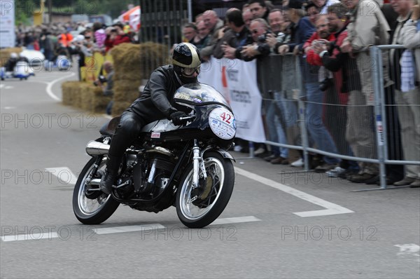 A motorcyclist races past spectators on a closed-off race track, SOLITUDE REVIVAL 2011, Stuttgart, Baden-Wuerttemberg, Germany, Europe
