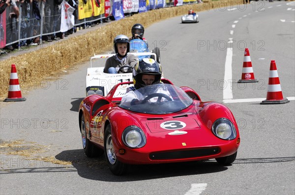 Red racing car driven by a driver with helmet in a field of drivers, SOLITUDE REVIVAL 2011, Stuttgart, Baden-Wuerttemberg, Germany, Europe