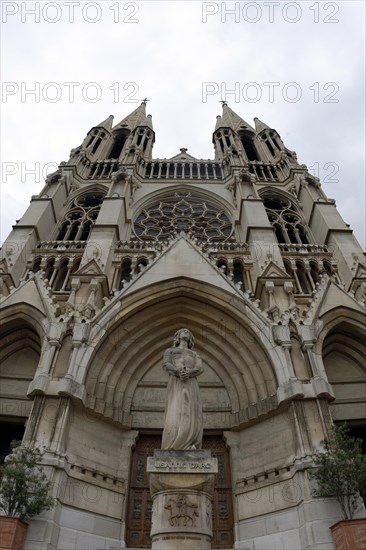 Church of Saint-Vincent-de-Paul, Detailed front view of a Gothic-style church facade with central statue, Marseille, Departement Bouches-du-Rhone, Provence-Alpes-Cote d'Azur region, France, Europe