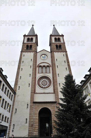 Romanesque UNESCO Kilian Cathedral, St Kilian, Cathedral, front view of a church tower with a clock and two pointed towers in front of a cloudy sky, Wuerzburg, Lower Franconia, Bavaria, Germany, Europe