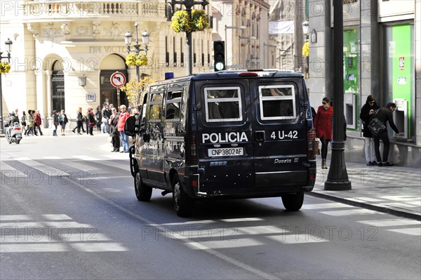 Granada, Police vehicle in a busy city street with pedestrians and shops, Andalusia, Spain, Europe Ceramic street sign of the, Europe