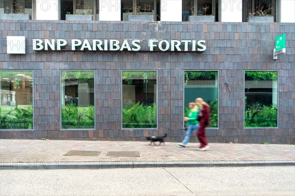 Shoppers walking past BNP Paribas Fortis bank office in the city centre of Ghent, Gent, East Flanders, Belgium, Europe