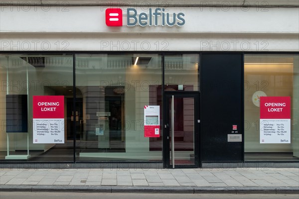 Office window showing opening hours of Belfius bank branch in the city Ghent, East Flanders, Belgium, Europe