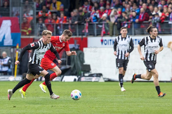 Football match, Robin HACK Borussia Moenchengladbach left in a sprint with Jan SCHOePPNER 1.FC Heidenheim, right Rocco REITZ Borussia Moenchengladbach, football stadium Voith-Arena, Heidenheim