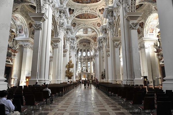 St Stephan's Cathedral, Passau, wide nave with pews and ceiling frescoes, some visitors can be seen, Passau, Bavaria, Germany, Europe