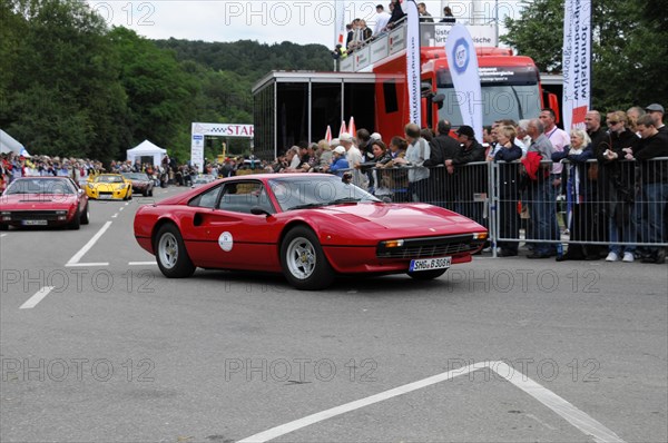A red classic car at a motorsport event in front of an enthusiastic audience, SOLITUDE REVIVAL 2011, Stuttgart, Baden-Wuerttemberg, Germany, Europe