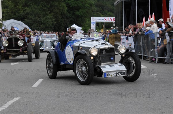 A blue-metallic vintage car drives on a road at a racing event, surrounded by spectators, SOLITUDE REVIVAL 2011, Stuttgart, Baden-Wuerttemberg, Germany, Europe