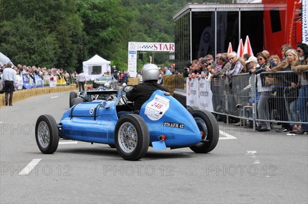 A blue classic racing car with driver in helmet drives past spectators, SOLITUDE REVIVAL 2011, Stuttgart, Baden-Wuerttemberg, Germany, Europe