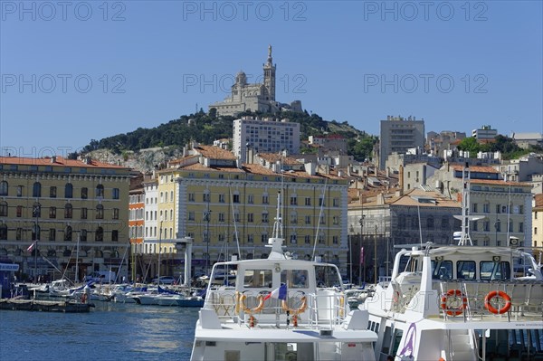 The old harbour, Vieux Port, behind the basilica Notre-Dame de la Garde, view of a harbour with boats and a fortress on a hill in the background, Marseille, Departement Bouches-du-Rhone, Region Provence-Alpes-Cote d'Azur, France, Europe