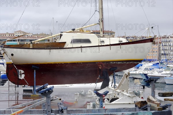 Marseille, An old sailing boat on the dry dock surrounded by cranes, Marseille, Departement Bouches-du-Rhone, Region Provence-Alpes-Cote d'Azur, France, Europe