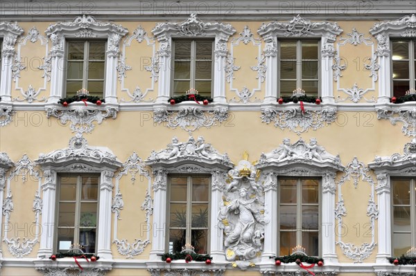 Facade view of the Falkenhaus with stucco facade in rococo style in the centre of Wuerzburg, rococo facade in white and gold with Christmas accents on the windows, Wuerzburg, Lower Franconia, Bavaria, Germany, Europe