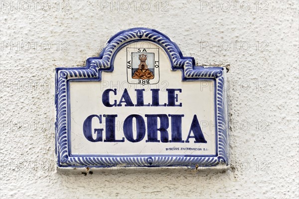 Solabrena, Ceramic street sign 'Calle Gloria' with blue and white lettering and ornaments, Andalusia, Spain, Europe