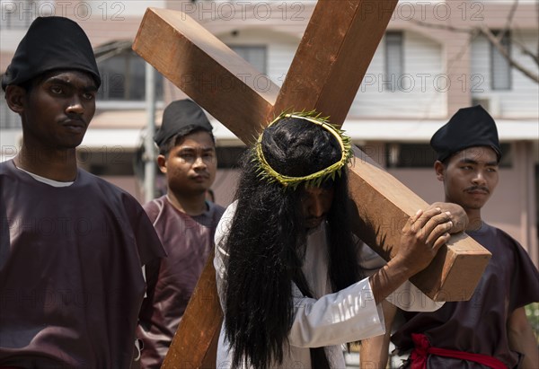 Christian devotees takes part in a perform to re-enactment of the crucifixion of Jesus Christ during a procession on Good Friday, on March 29, 2024 in Guwahati, Assam, India. Good Friday is a Christian holiday commemorating the crucifixion of Jesus Christ and his death at Calvary