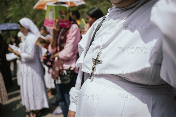 A nun wears a Cross as she recite prayers during a re-enactment of the crucifixion of Jesus Christ to mark the Good Friday, on March 29, 2024 in Guwahati, Assam, India. Good Friday is a Christian holiday commemorating the crucifixion of Jesus Christ and his death at Calvary