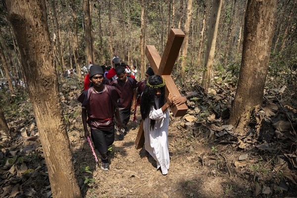 Christian devotees takes part in a perform to re-enactment of the crucifixion of Jesus Christ during a procession on Good Friday, on March 29, 2024 in Guwahati, Assam, India. Good Friday is a Christian holiday commemorating the crucifixion of Jesus Christ and his death at Calvary