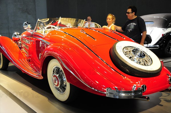 A bright red convertible vintage car at an exhibition, Mercedes-Benz Museum, Stuttgart, Baden-Wuerttemberg, Germany, Europe
