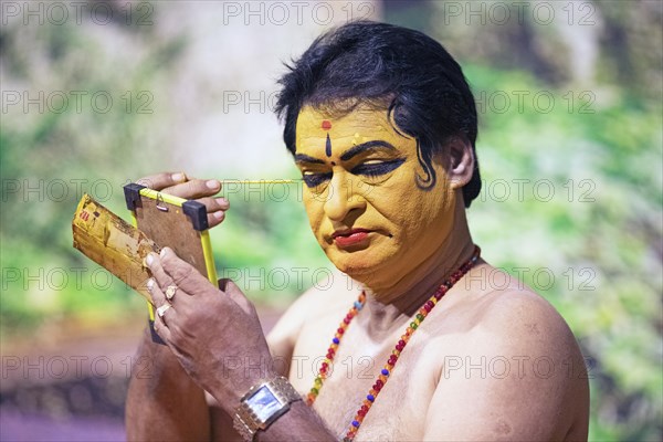Kathakali performer or mime, 60 years old, makes up his face, Kochi Kathakali Centre, Kochi, Kerala, India, Asia