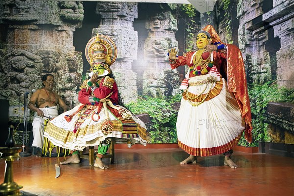 Kathakali performer or mime, 38 and 60 years old, and drummer on stage at the Kochi Kathakali Centre, Kochi, Kerala, India, Asia