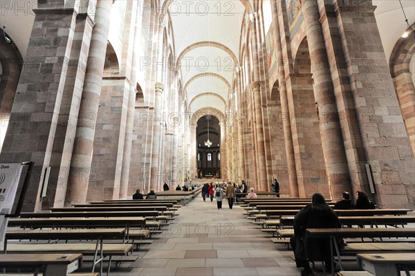 Speyer Cathedral, majestic church interior with people walking between columns and stained glass windows, Speyer Cathedral, Unesco World Heritage Site, foundation stone laid around 1030, Speyer, Rhineland-Palatinate, Germany, Europe